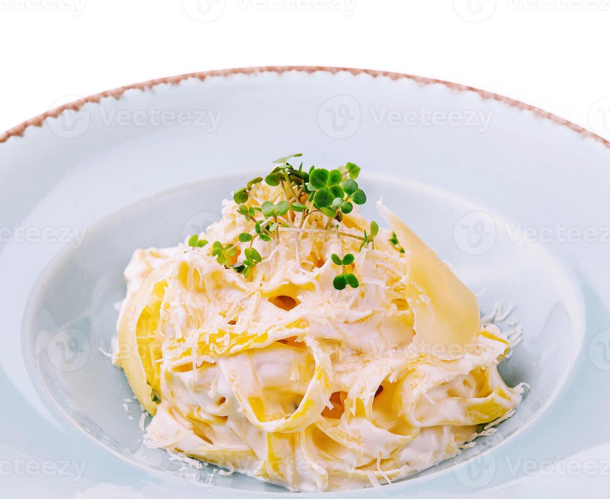 Tagliatelle pasta with cream sauce and parmesan cheese photo