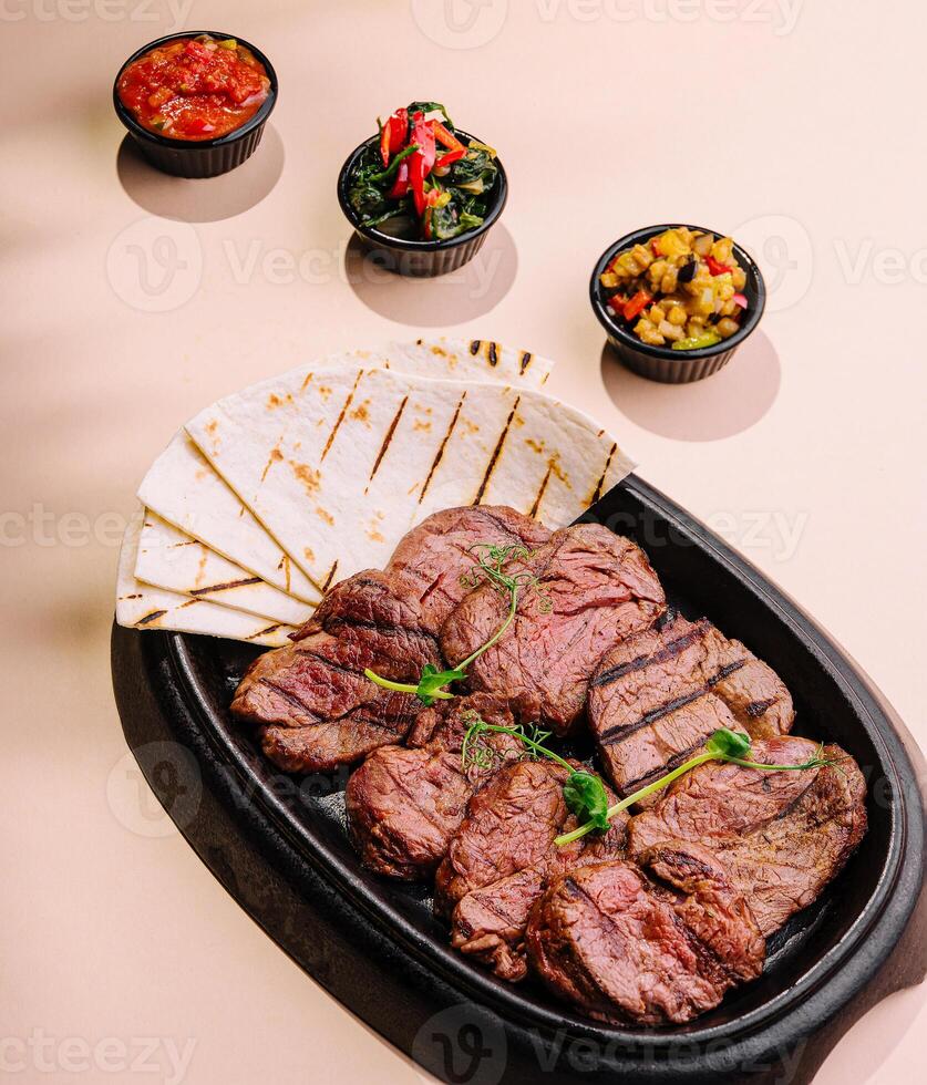 Grilled meat steak veal medallions with pita photo