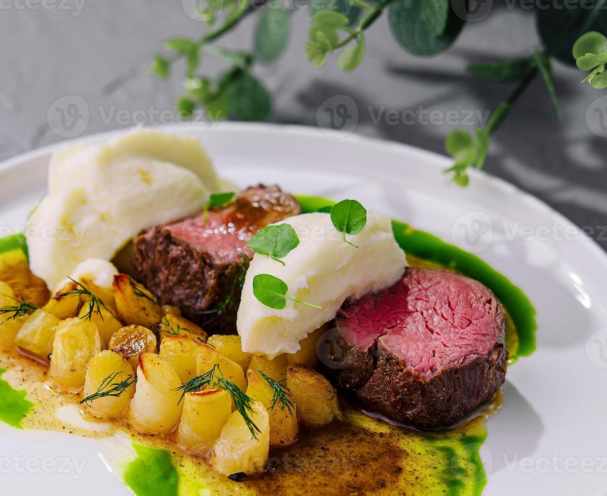 beef medallions with mashed potatoes and celery photo