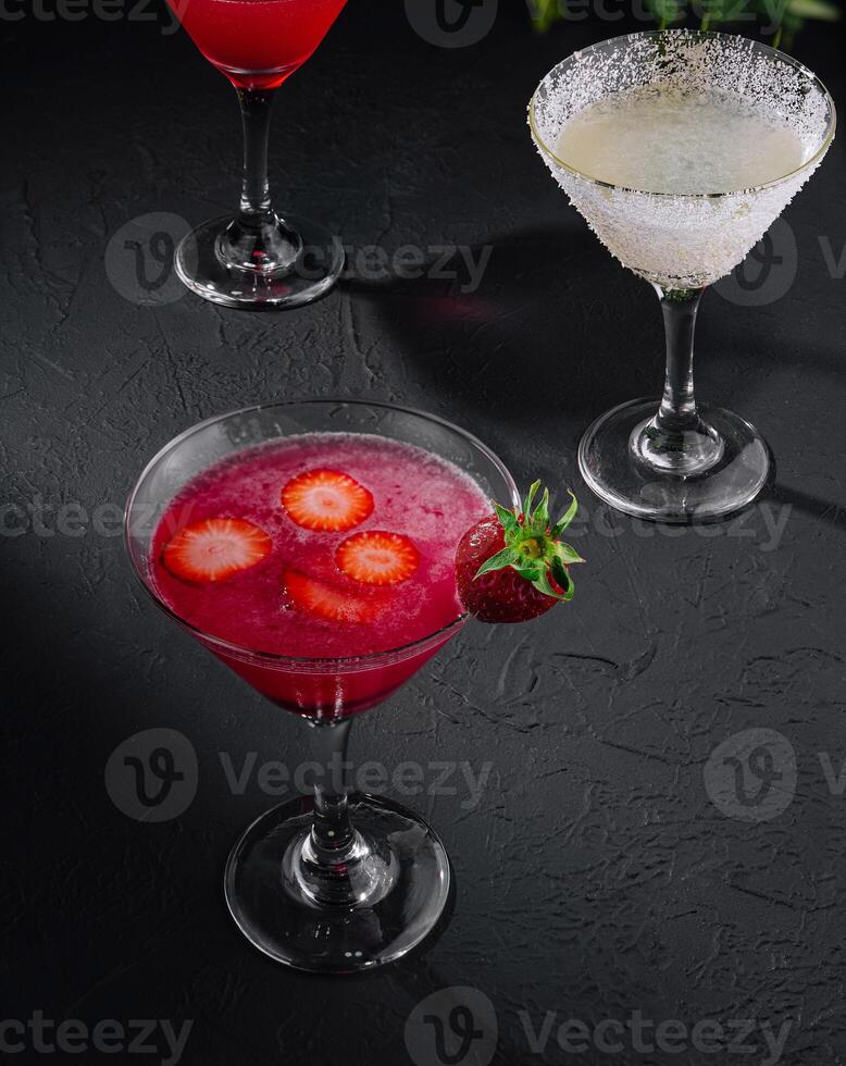 martini glasses of red and coconut alcohol drinks photo