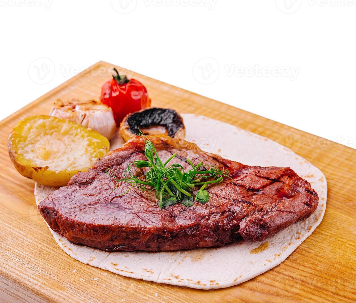 Delicious grilled pork chop on pita bread photo