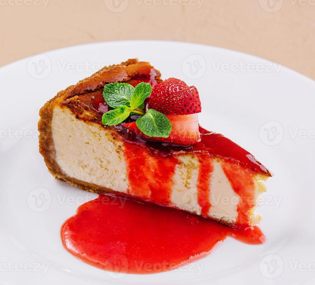 cheesecake with strawberry jam on plate photo