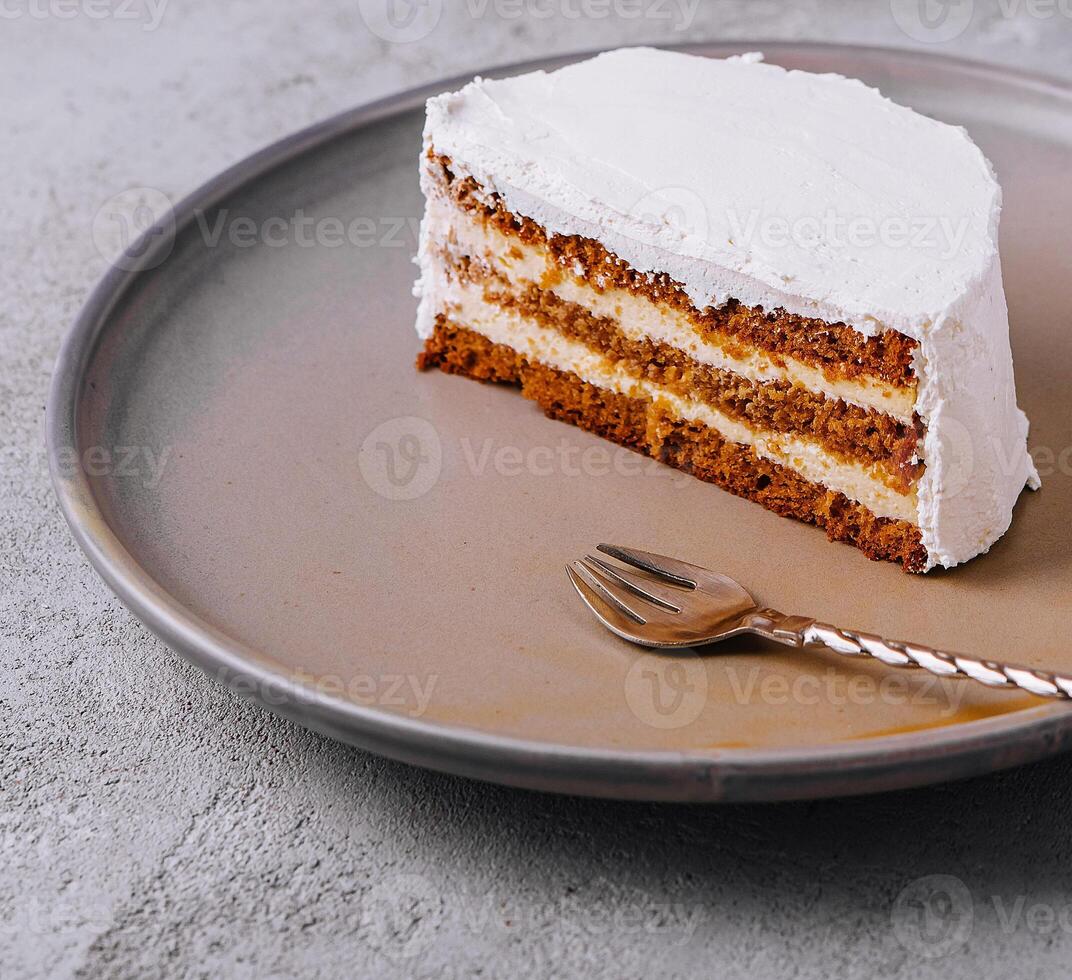 Carrot cake and cream cheese on plate photo