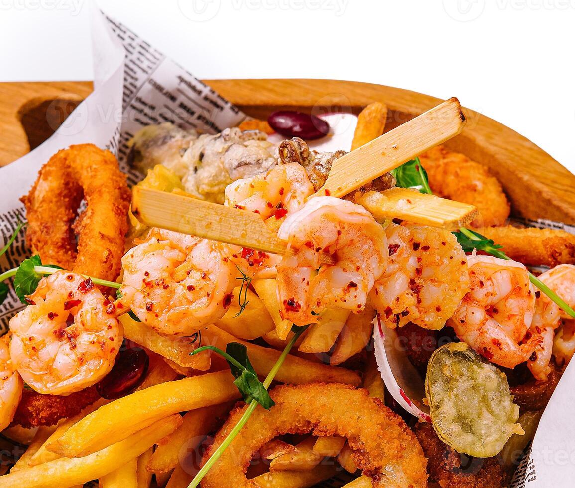fried seafood plate on wooden tray photo