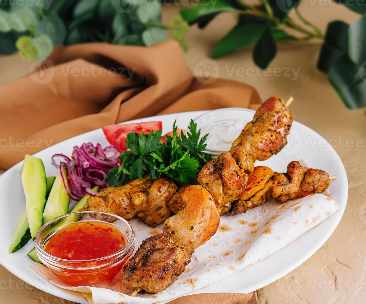 pork kebab on a wooden skewer on plate photo