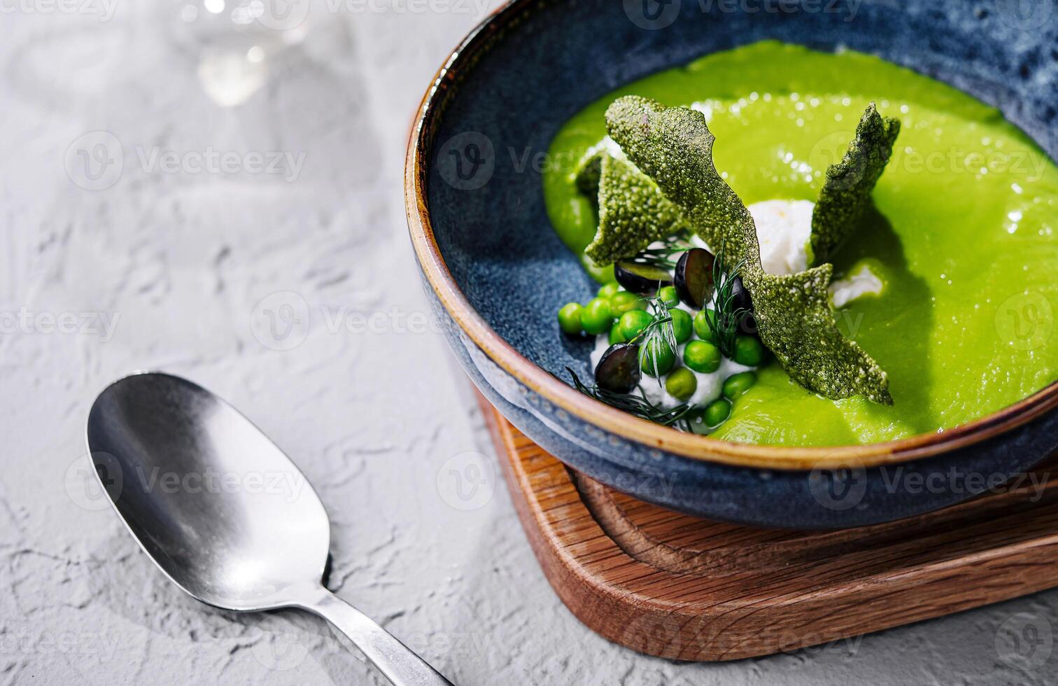 peas, broccoli, spinach cream soup in a bowl photo