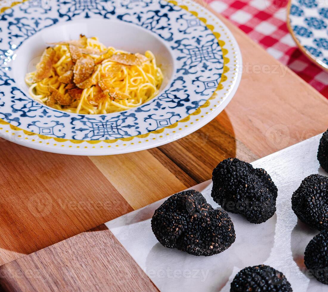 Chef Grating Truffle Shavings on Pasta with Parmesan photo