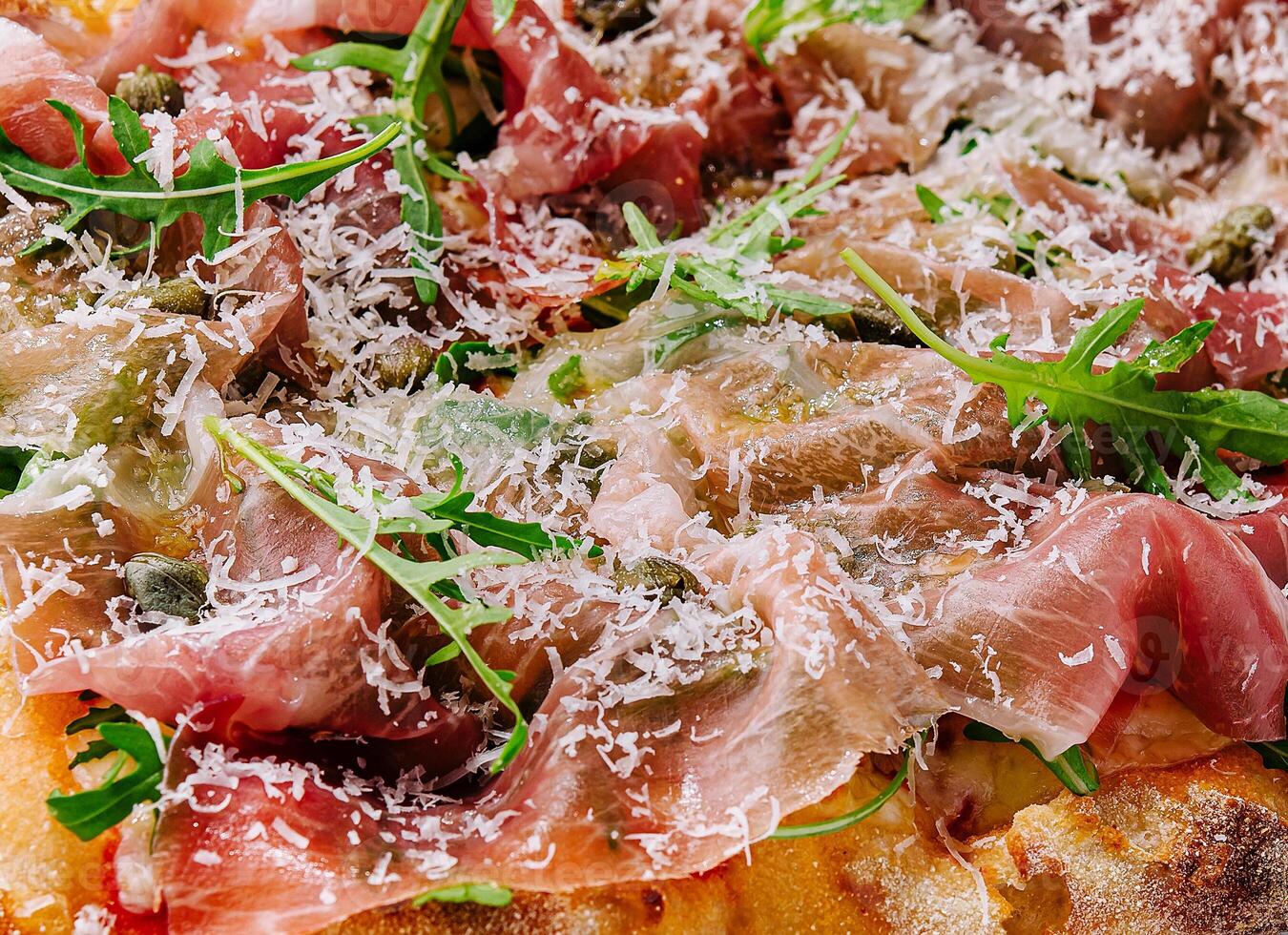 square pizza with prosciutto and arugula photo