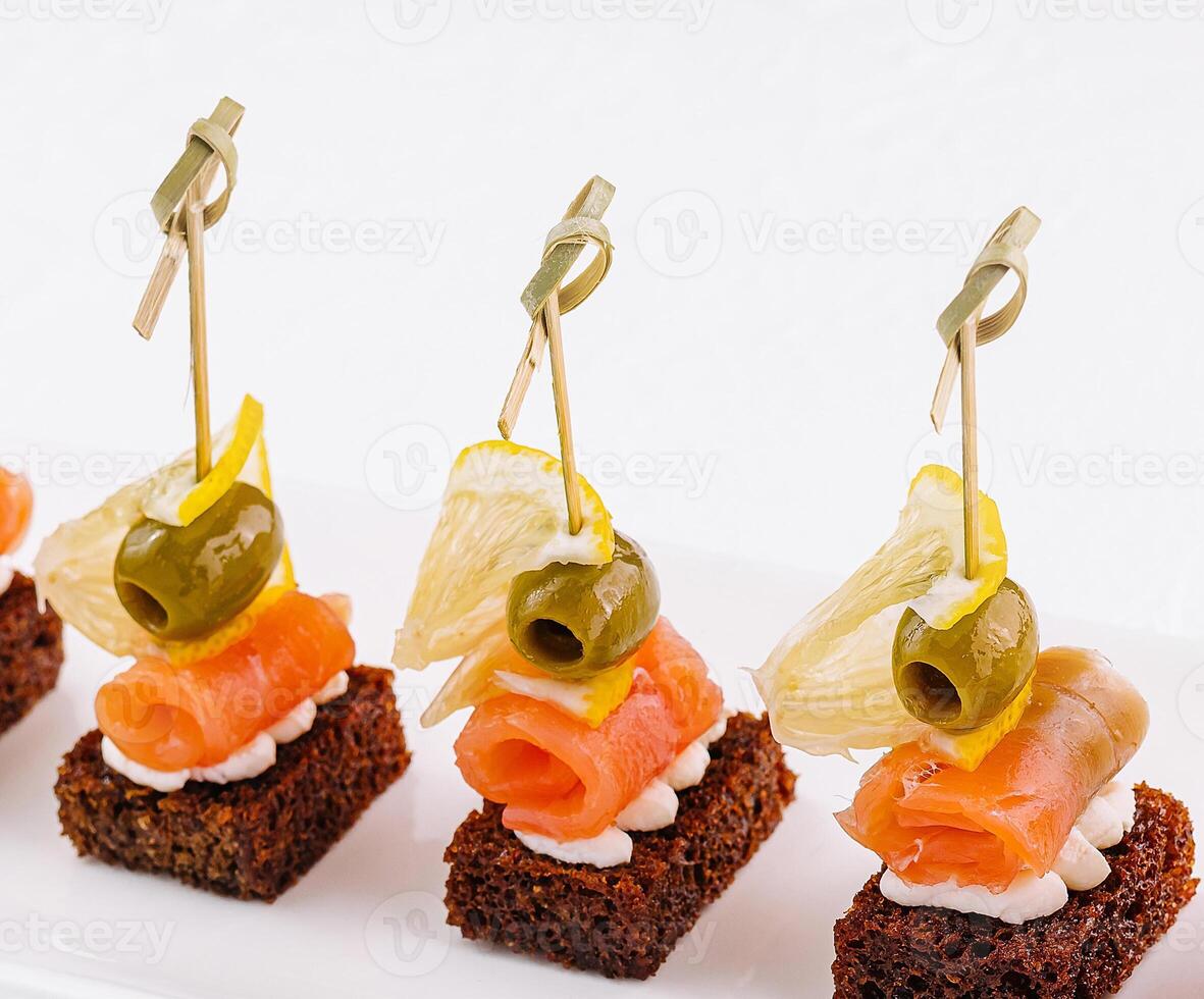 canapes with cheese and red fish photo