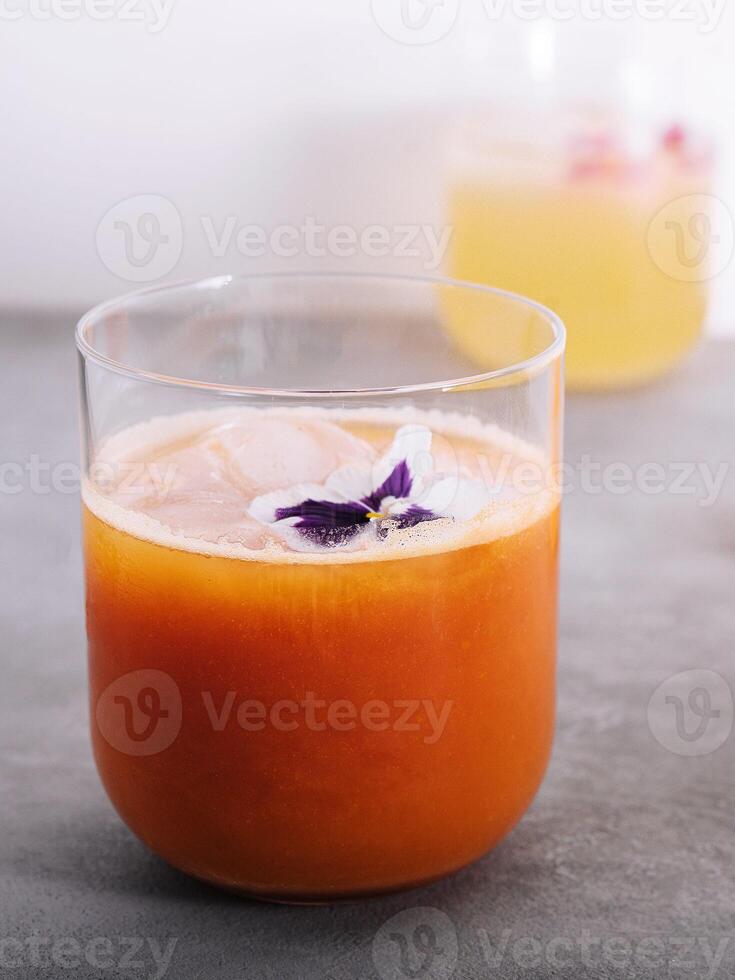 Fresh carrot juice and chamomile syrup with lemon photo