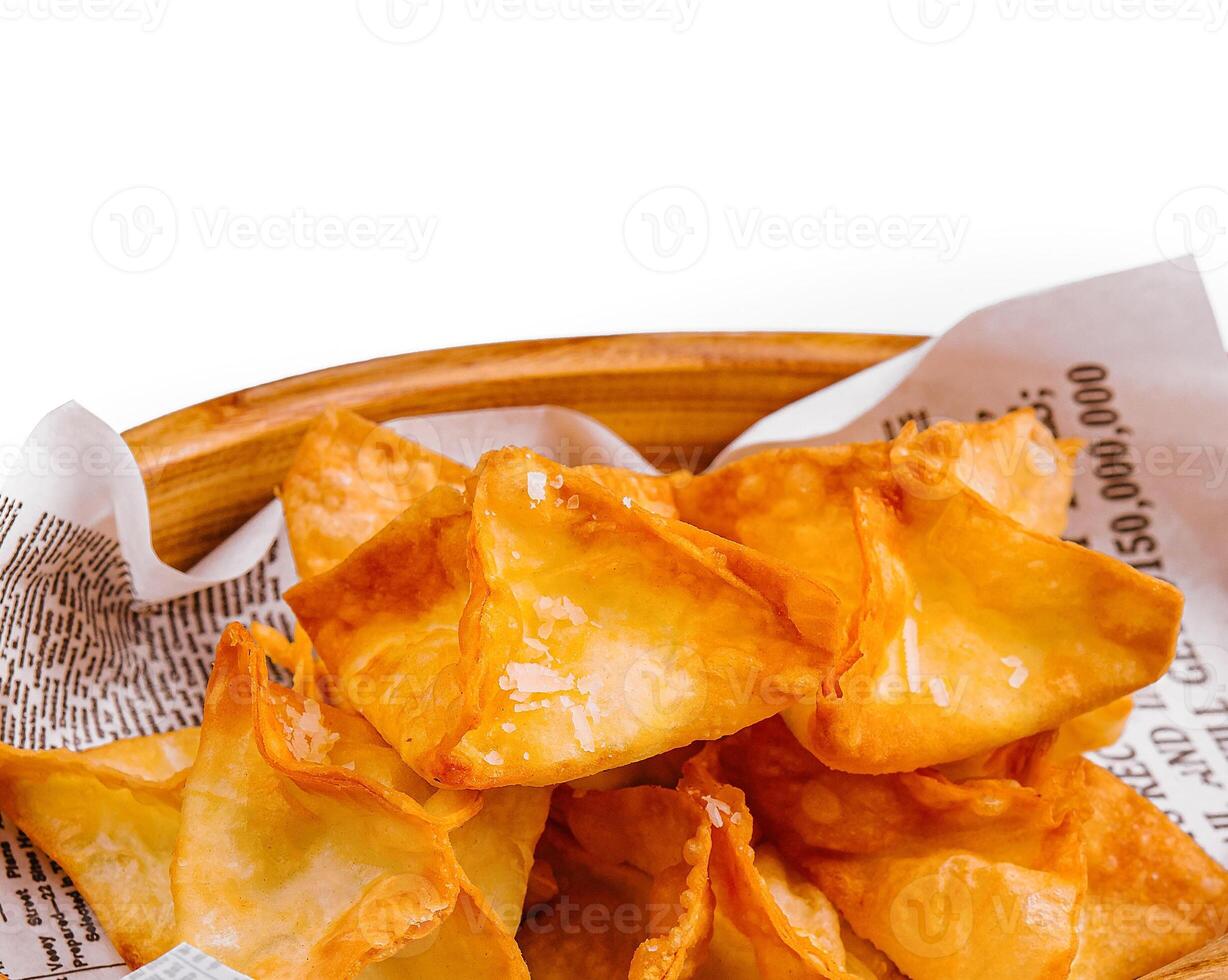 potato crisps with hot sauce isolated photo