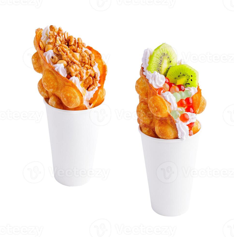 Bubble Waffle with kiwi, bubble tea, nuts and whipped cream photo