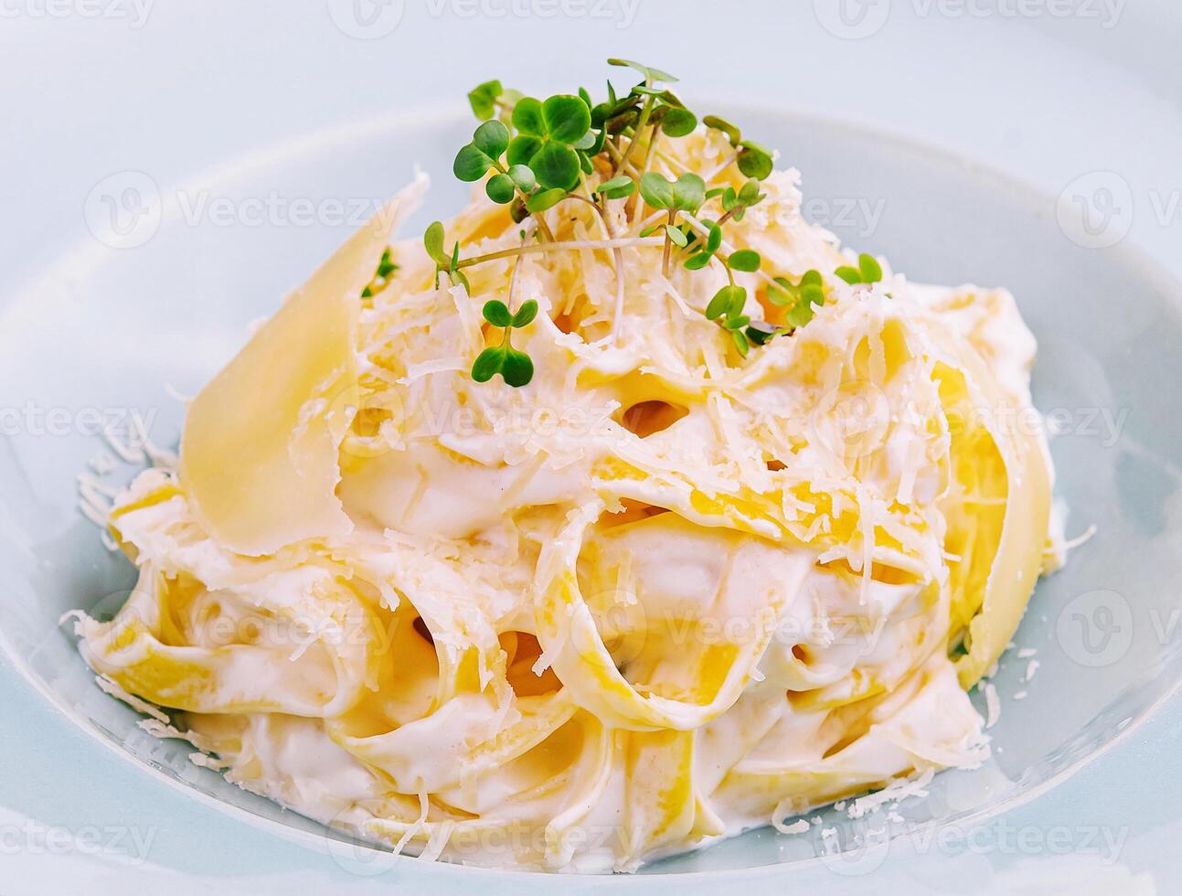 Tagliatelle pasta with cream sauce and parmesan cheese photo