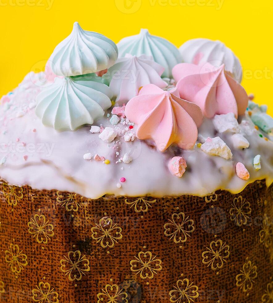 Traditional Easter cakes with meringue on yellow background photo