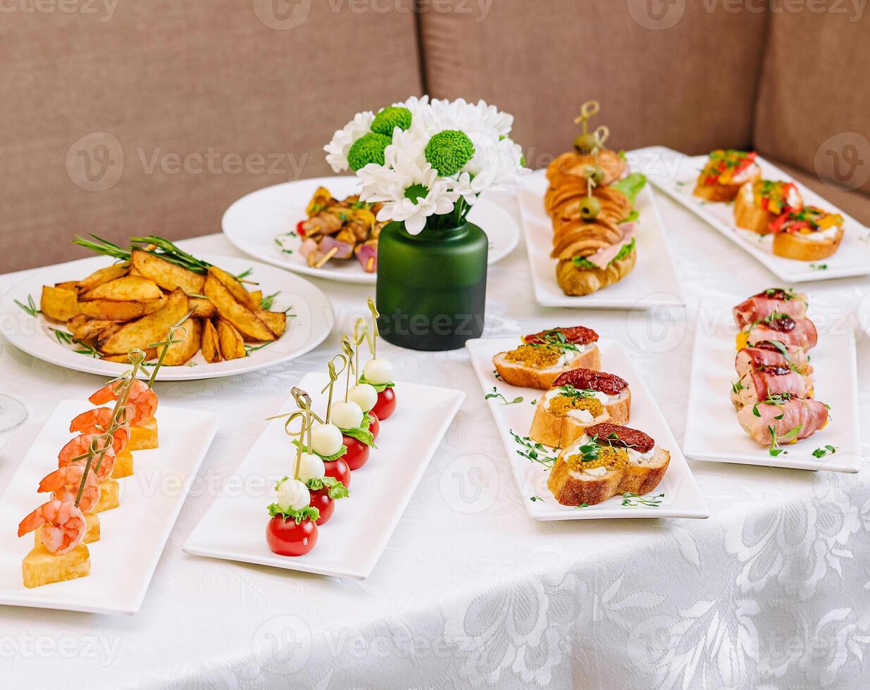 table with different gourmet snacks top view photo