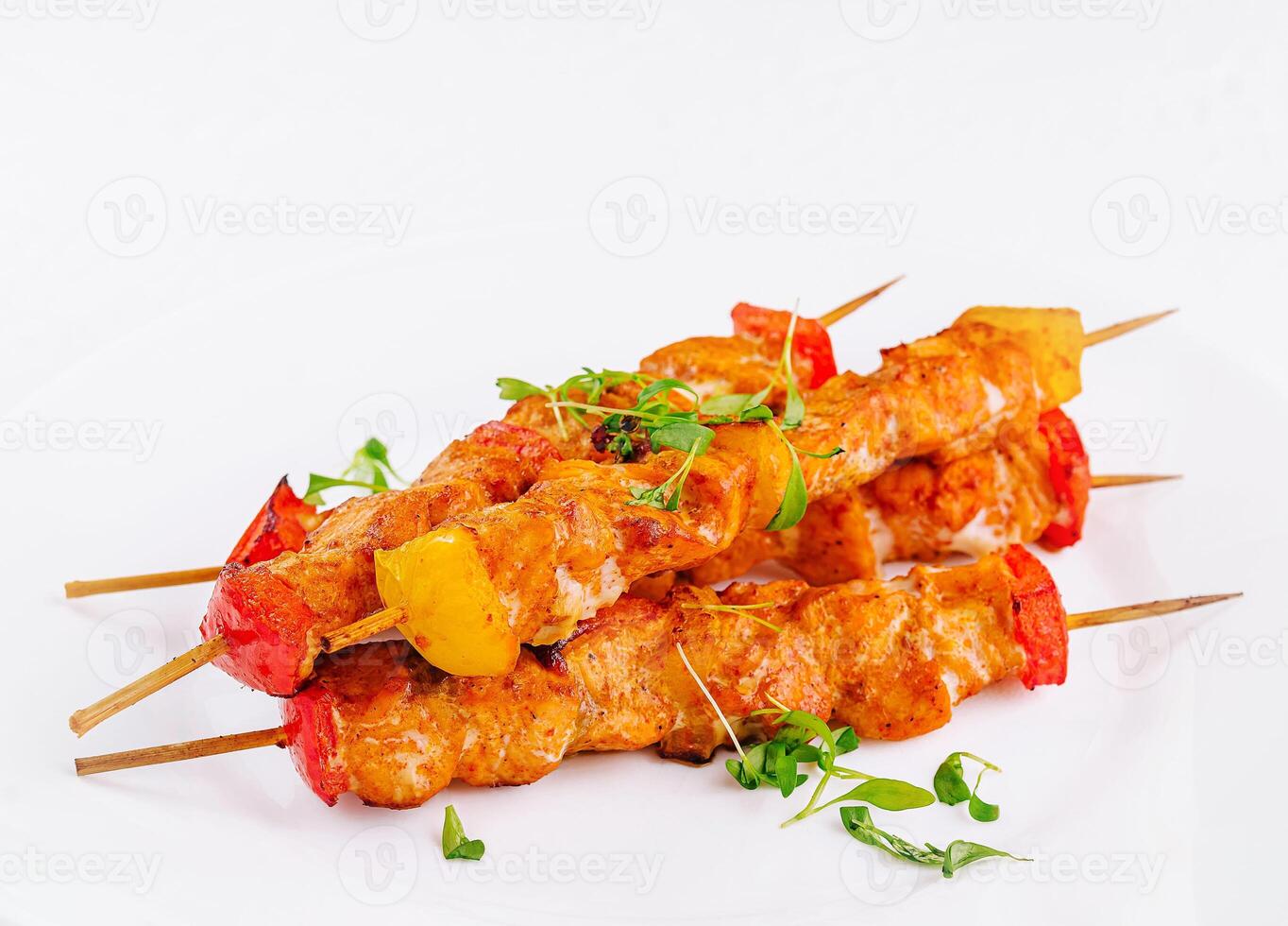 Chicken skewers with slices of sweet peppers photo