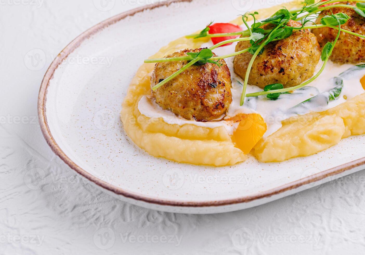 Meatballs with mashed potatoes on white plate photo