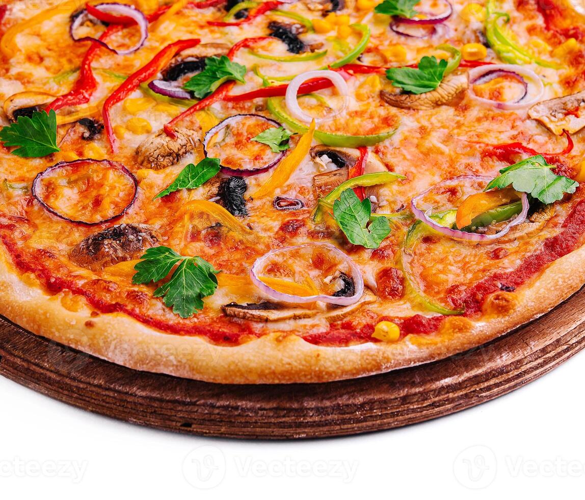 Delicious hot vegetable pizza on wood photo