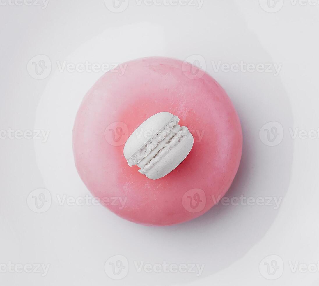 Pink mousse cake decorated with white macaroon photo