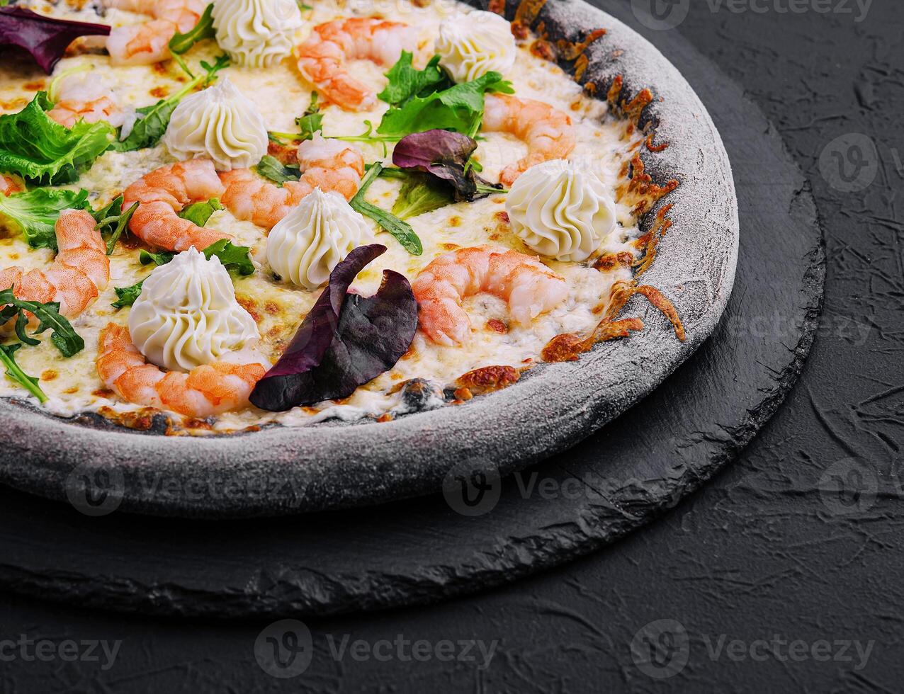 black pizza with shrimp and cream photo