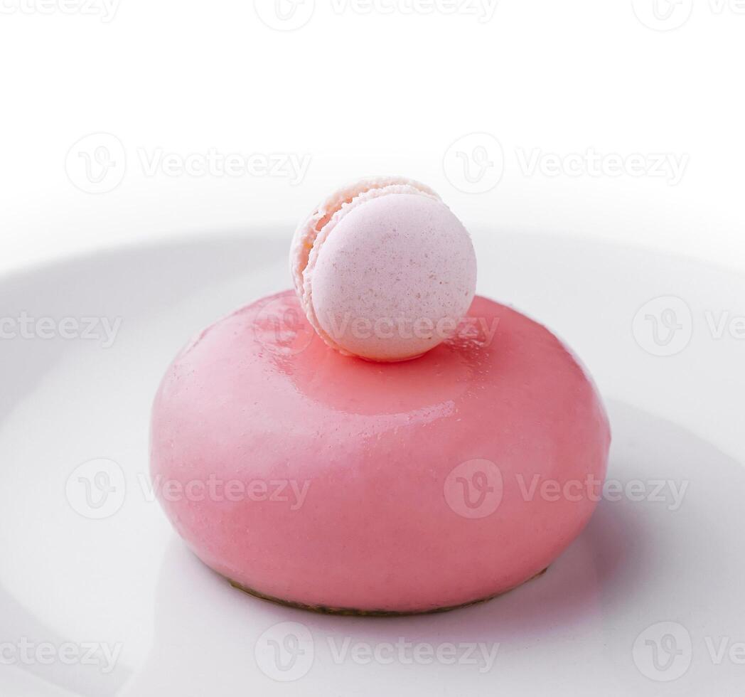 Pink mousse cake decorated with white macaroon photo