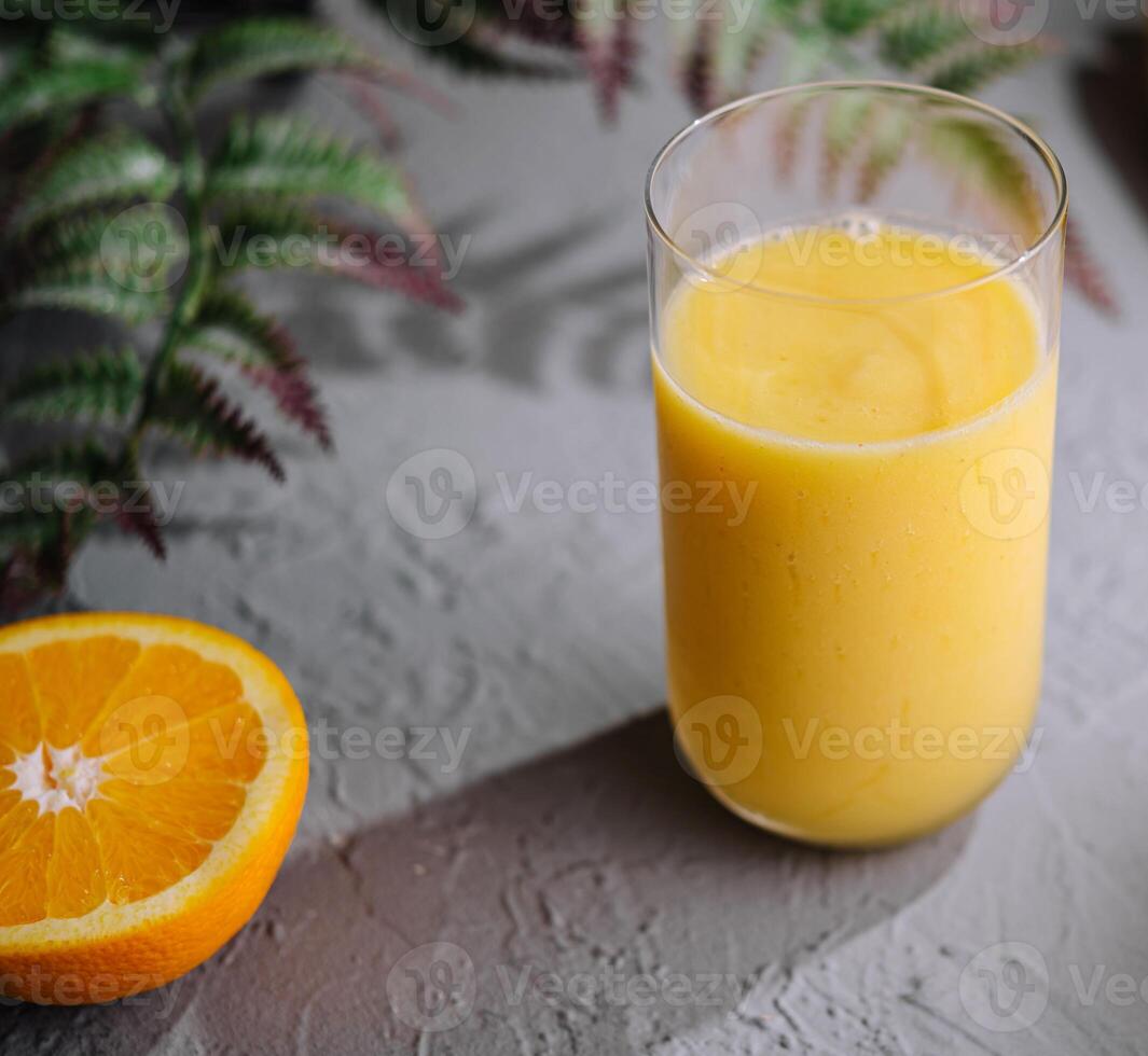 Yellow smoothie of mango, banana and orange photo