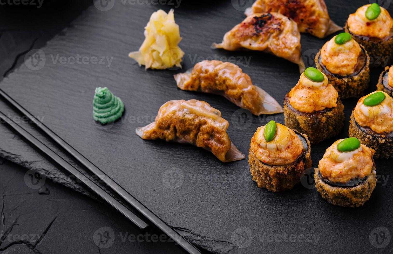 Gyoza or dumplings snack and warm sushi top view photo