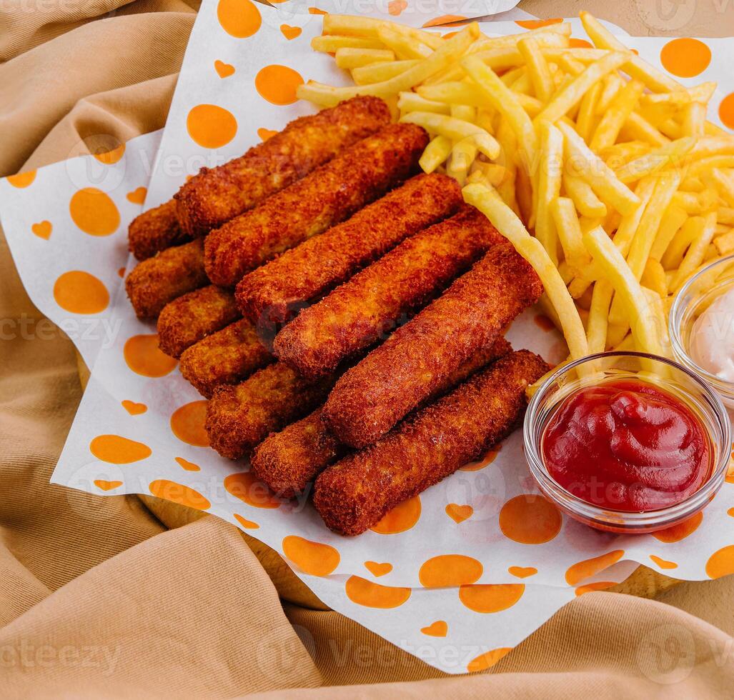french fries with chicken nuggets and sauces photo