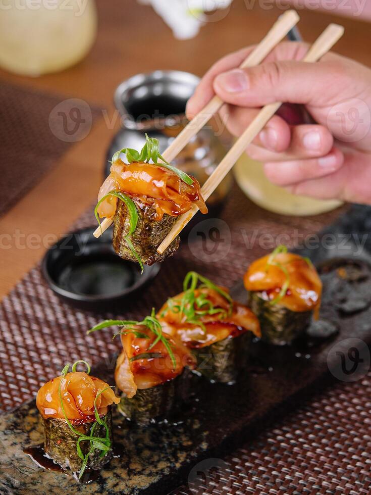 girl eats Japanese sushi gunkan salmon photo