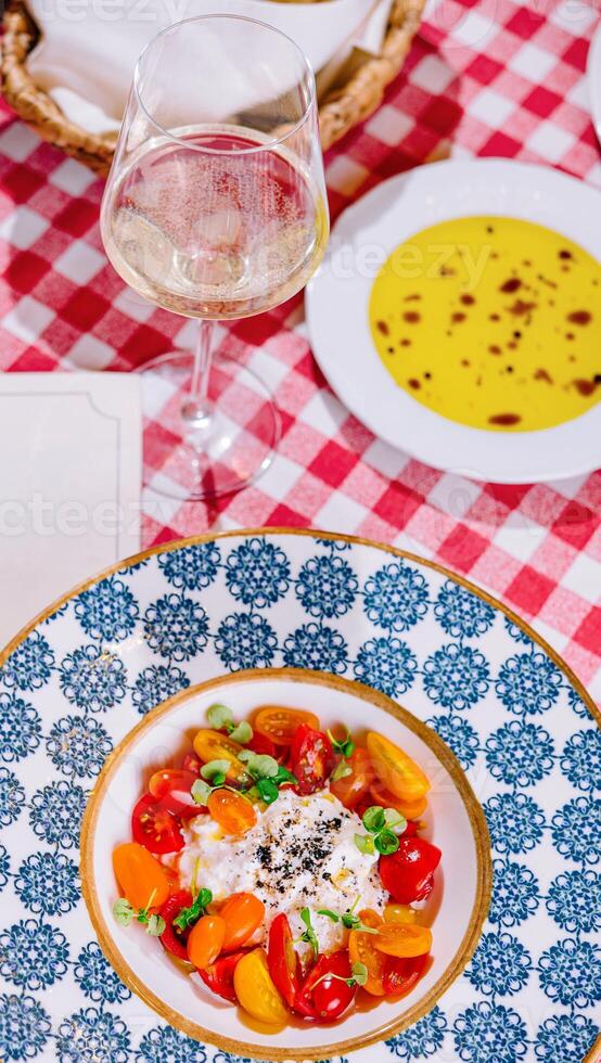 Caprese salad with tomatoes, mozzarella, basil, pesto photo