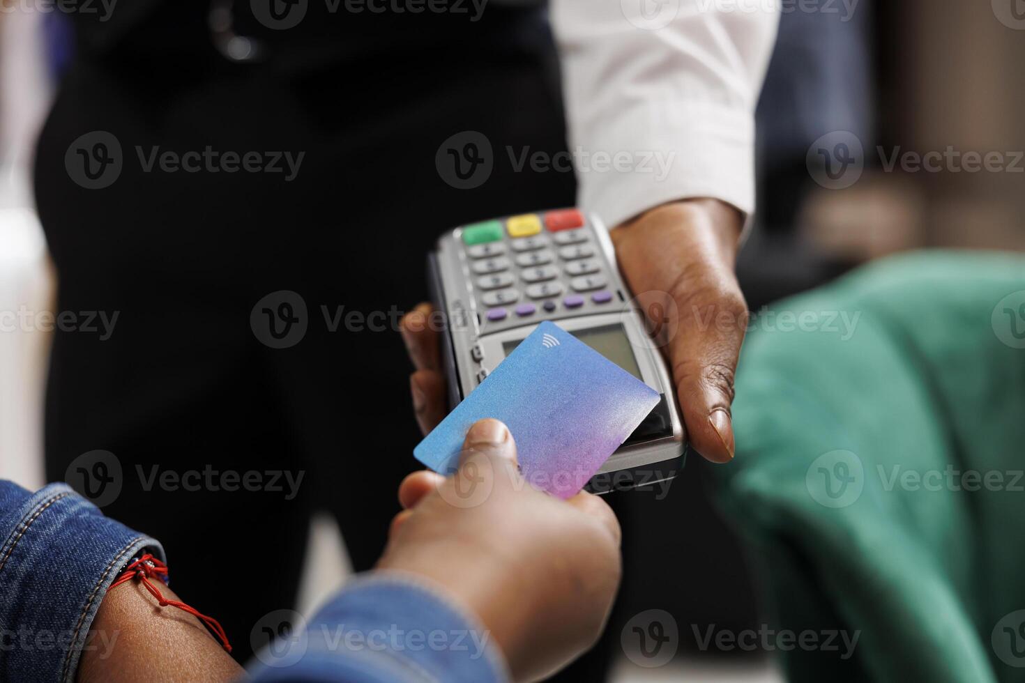 Cashless payments in hotels. Hospitality worker holding pos terminal accepting credit card payment from customer, close up of person making convenient and quick contactless transaction photo