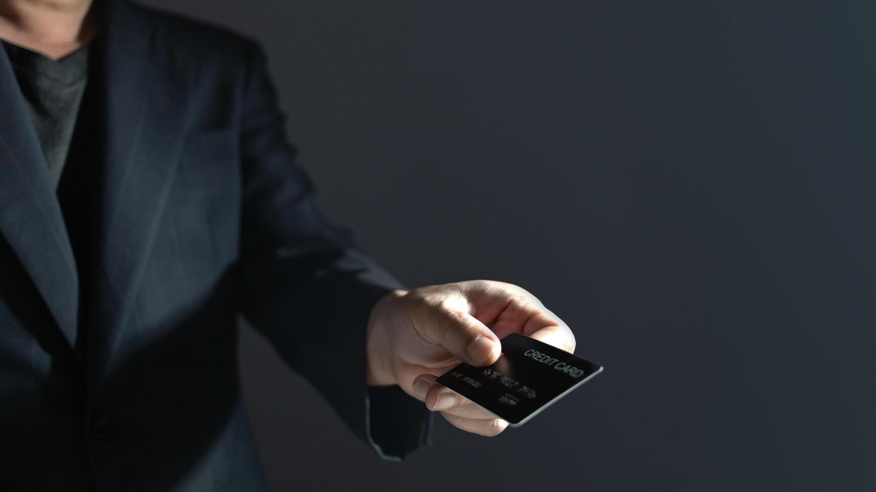 businessman showing a mock-up credit card for business and shopping to make payment and smartphone.half body. purchase, commerce, financial, card, money, using technology. selective focus. photo