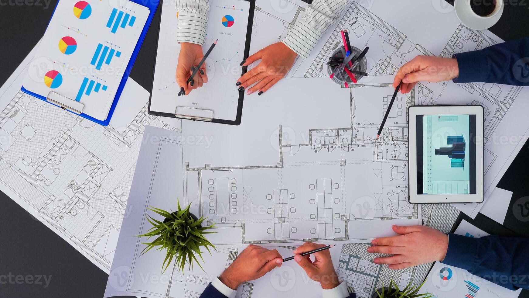 Top view of architects and engineers creating a blueprint to build modern building equipped with the skills to fix errors and making suggestions during construction photo