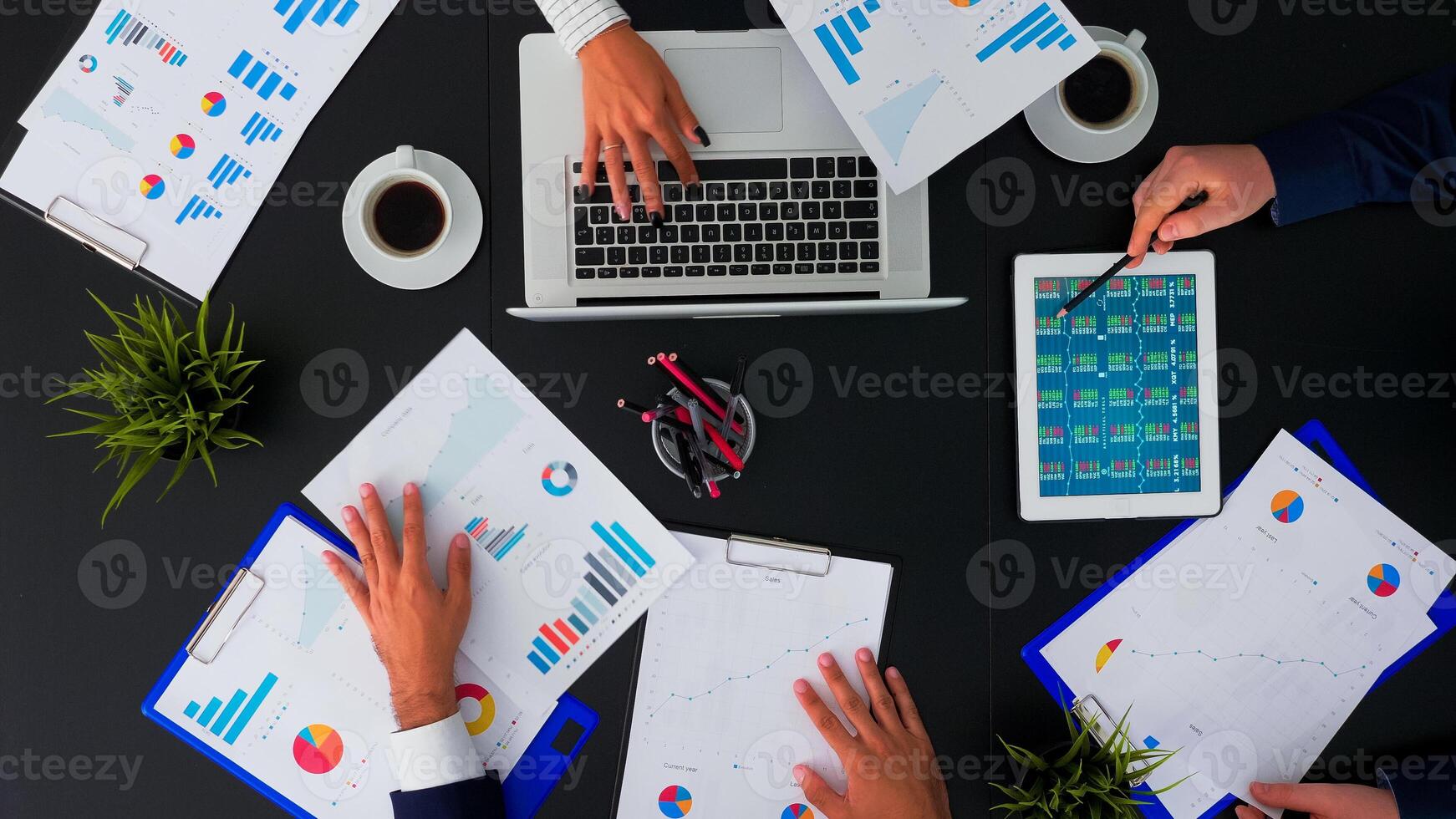 High angle view of professional business people meeting in conference room with company manager planning financial strategy using modern technology in corporate building. Copy space, flat lay concept photo