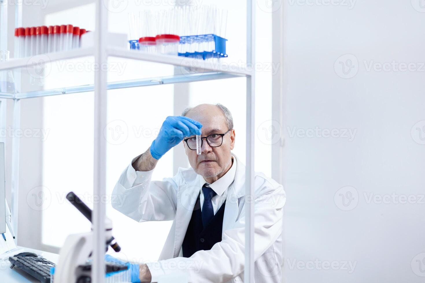 Senior scientist in sterile chemistry anlysing solution from test tube. Viorolog researcher in professional lab working to discover medical treatment. photo