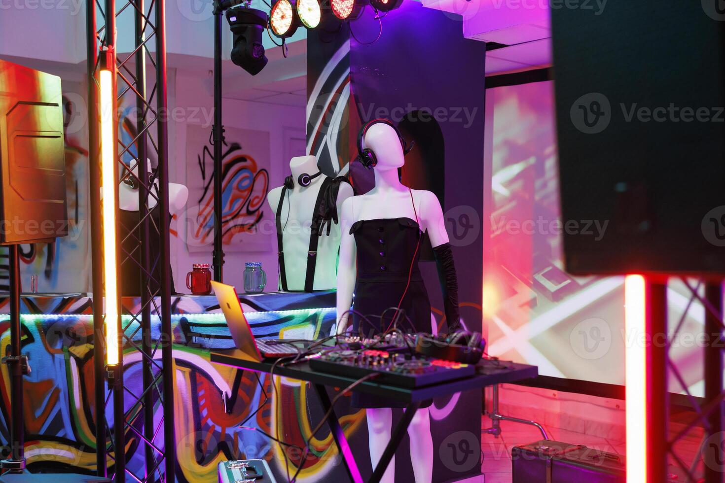 Musician sound mixer and mannequin in headset on stage in dark nightclub with spotlights. Dj controller equipment prepared for live performance and discotheque party in club photo