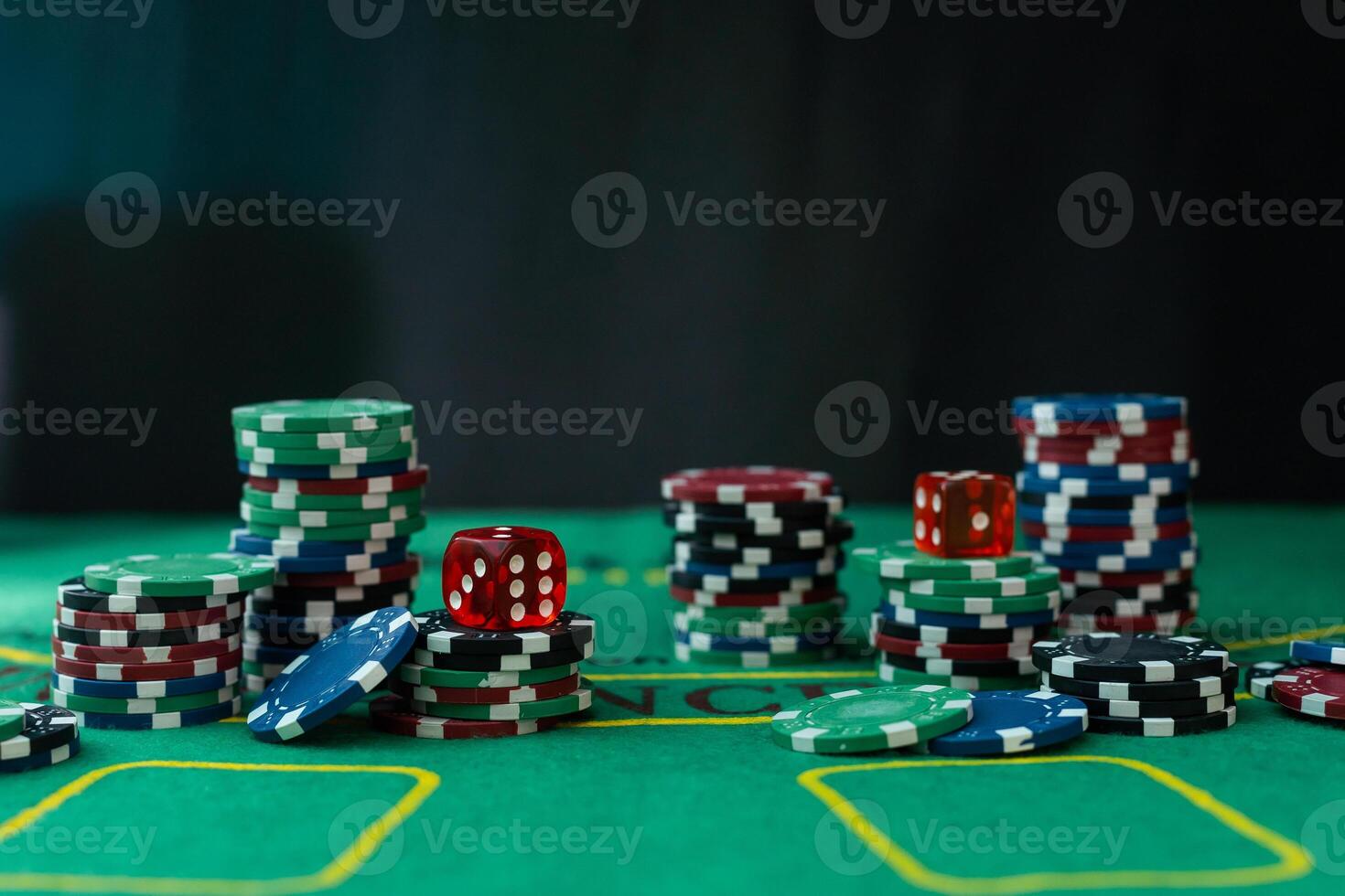A very close up shot of 2 dice rolling on a green felt table top in very crisp focus, showing 4, 5 and 6 on the faces. photo