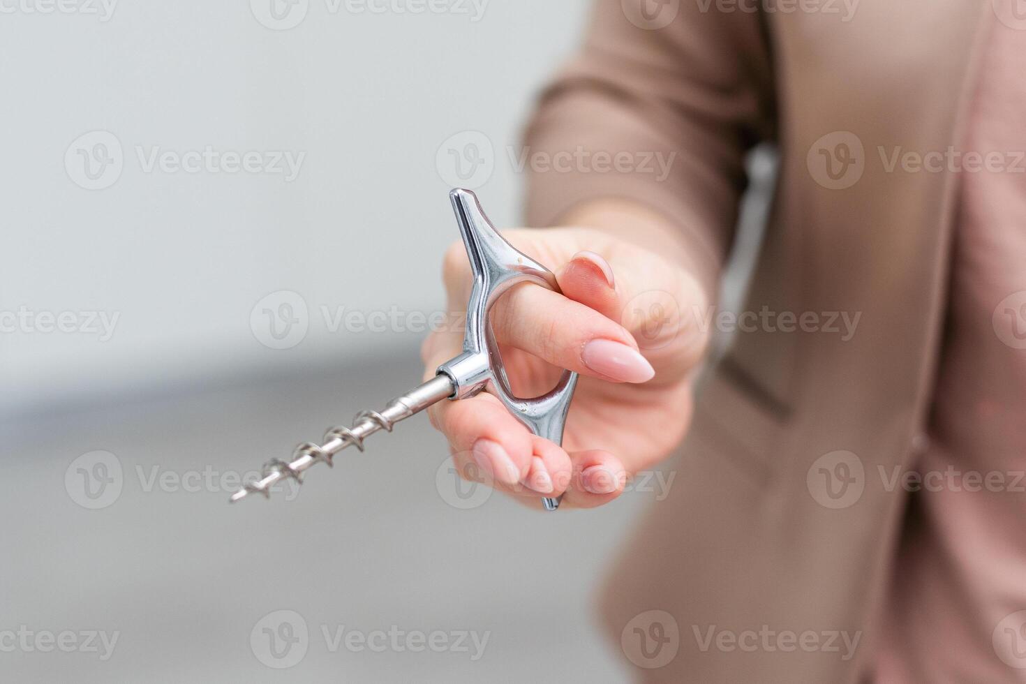 Hand holding corkscrew isolated on white background. Clipping path photo