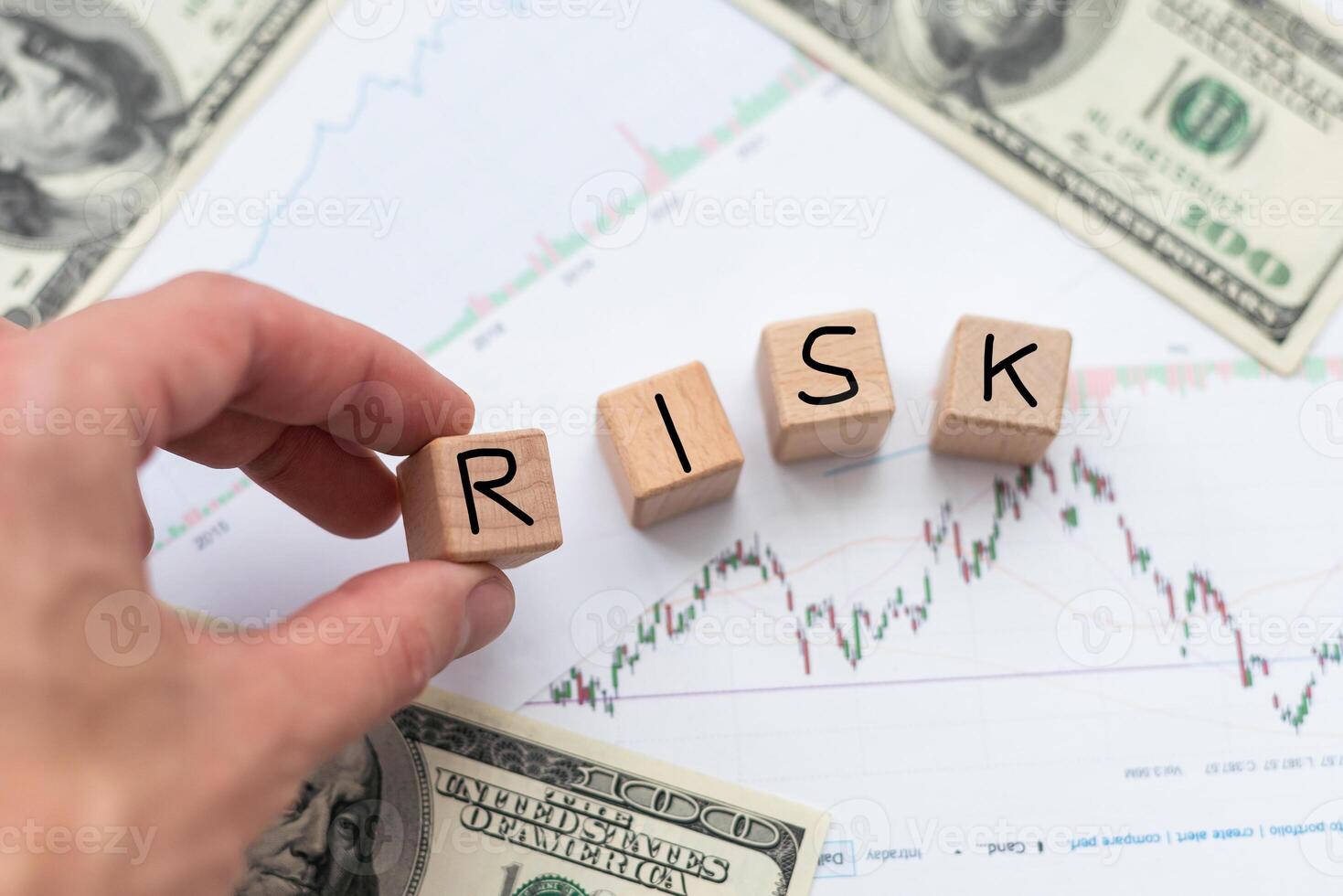 Risk in business investment. Word risk white in the wood block on paper analyse financial graph. Investment Concept. photo