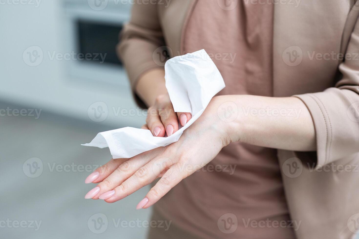 Woman hand use antibacterial wet wipes or tissue isolated on a white background with clipping path. Concept of hygiene and protection from Covid-19 photo