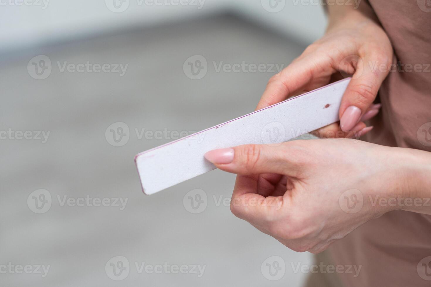 manicure and pedicure nail file in a hand isolated on white background. cosmetic tool photo