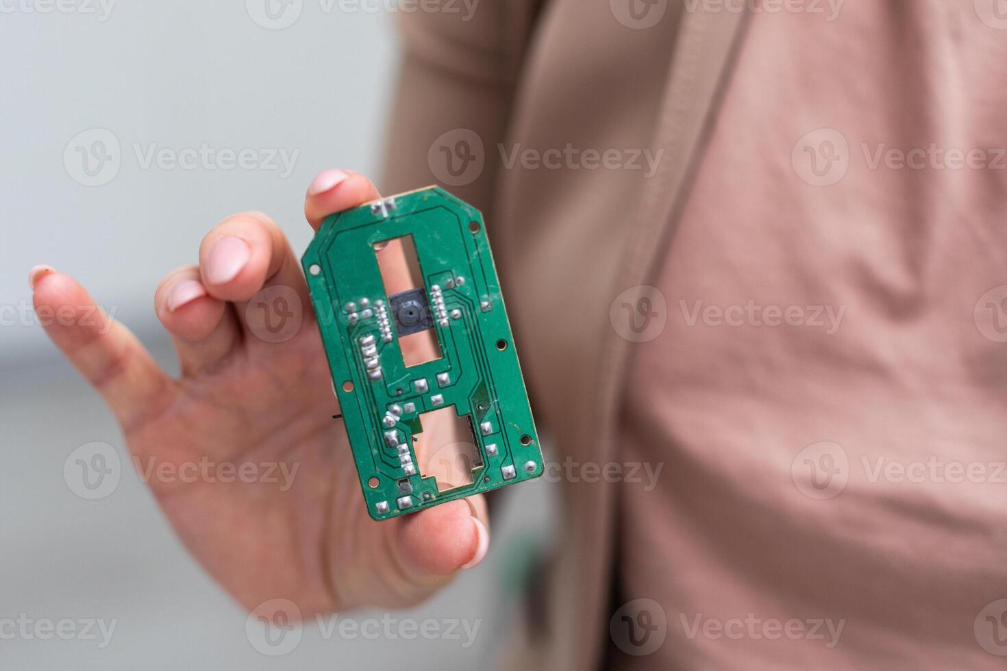 Hand holding IC chip ipod isolated on white photo