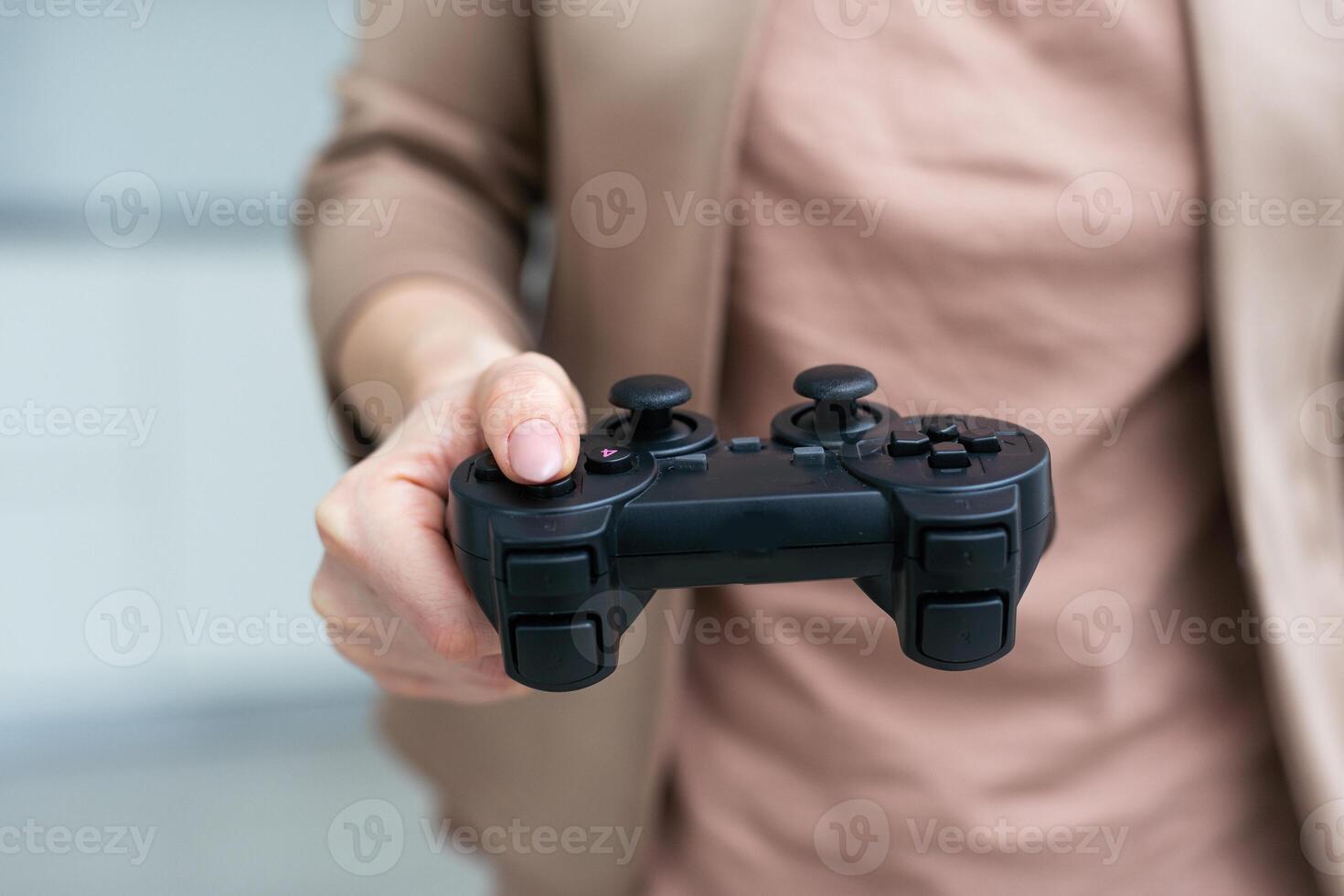 Womans hand playing video game against white background photo