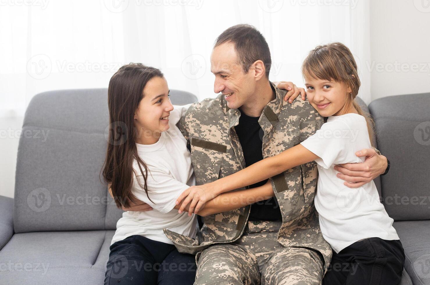 Soldier with his little children at home photo
