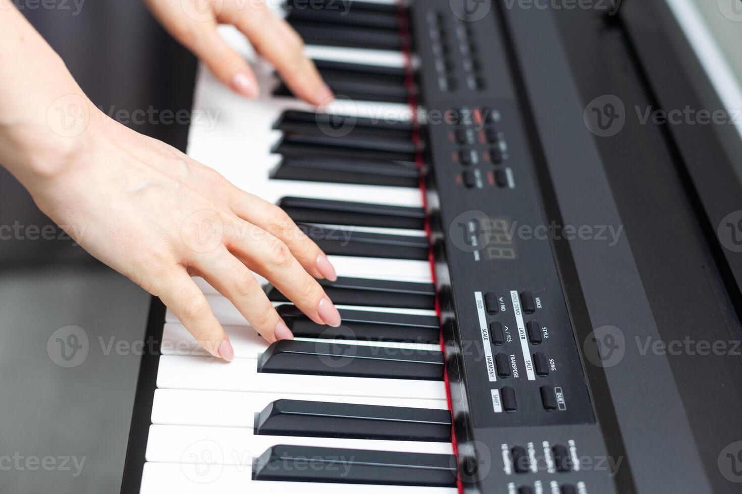 keyboard and hands playing the piano photo