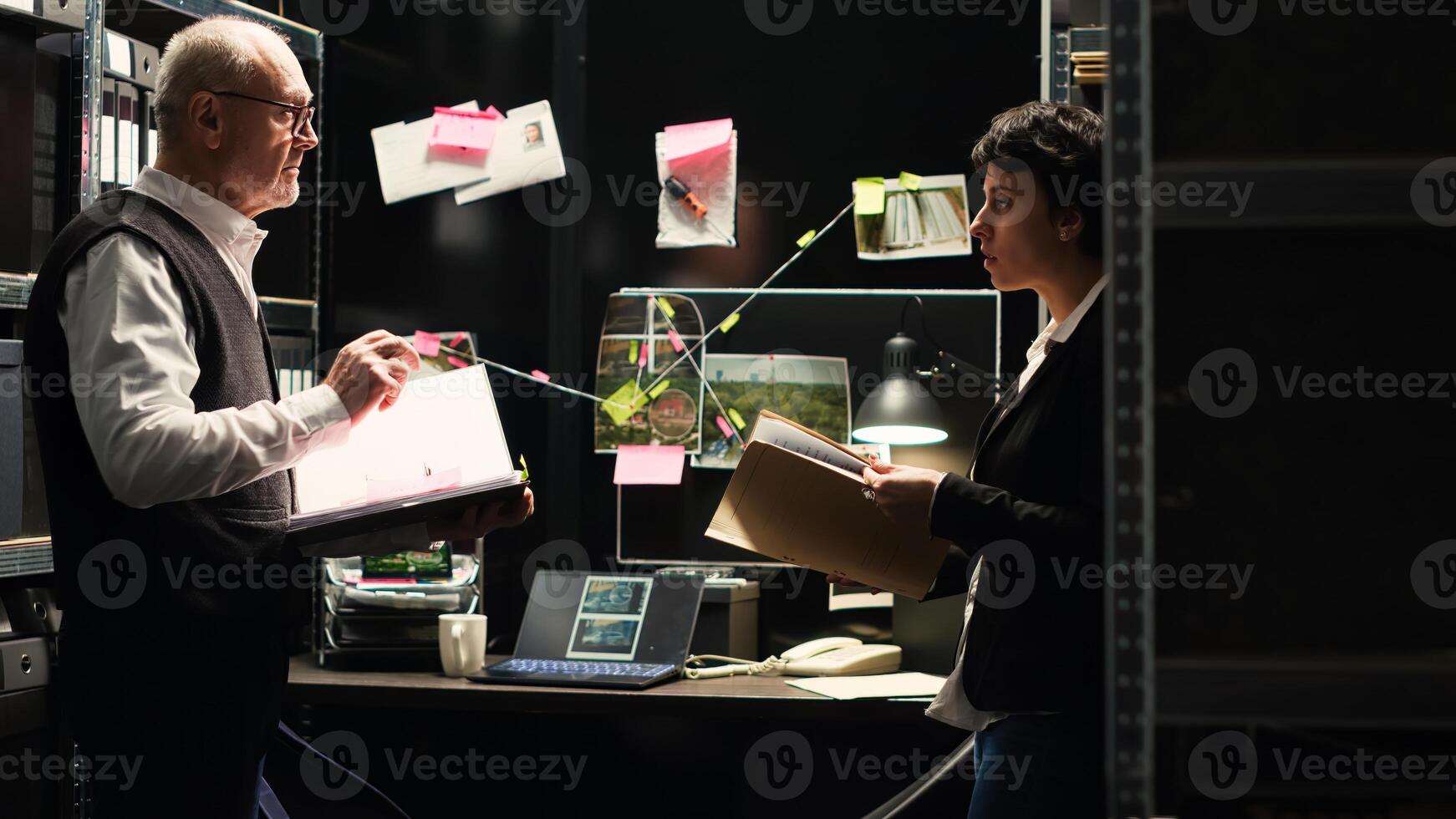 Law agents read witness statements to connect the dots in solving criminal case, using classified documents to find the missing puzzle piece. Professional investigators clandestine operation. photo