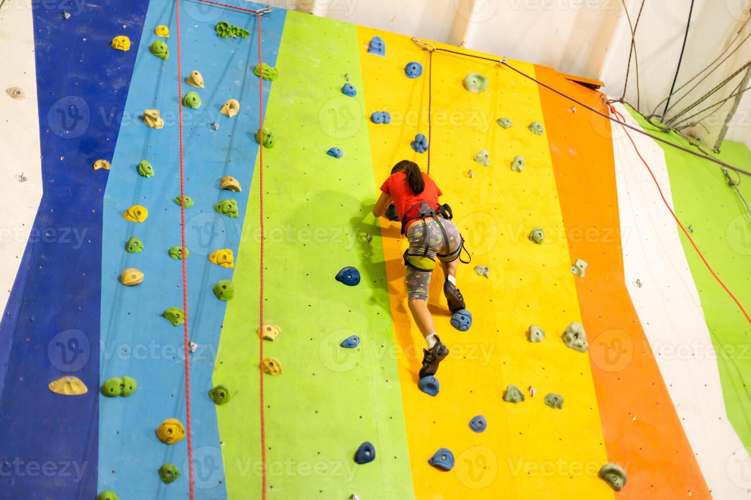 Little Girl Climbing Rock Wall photo