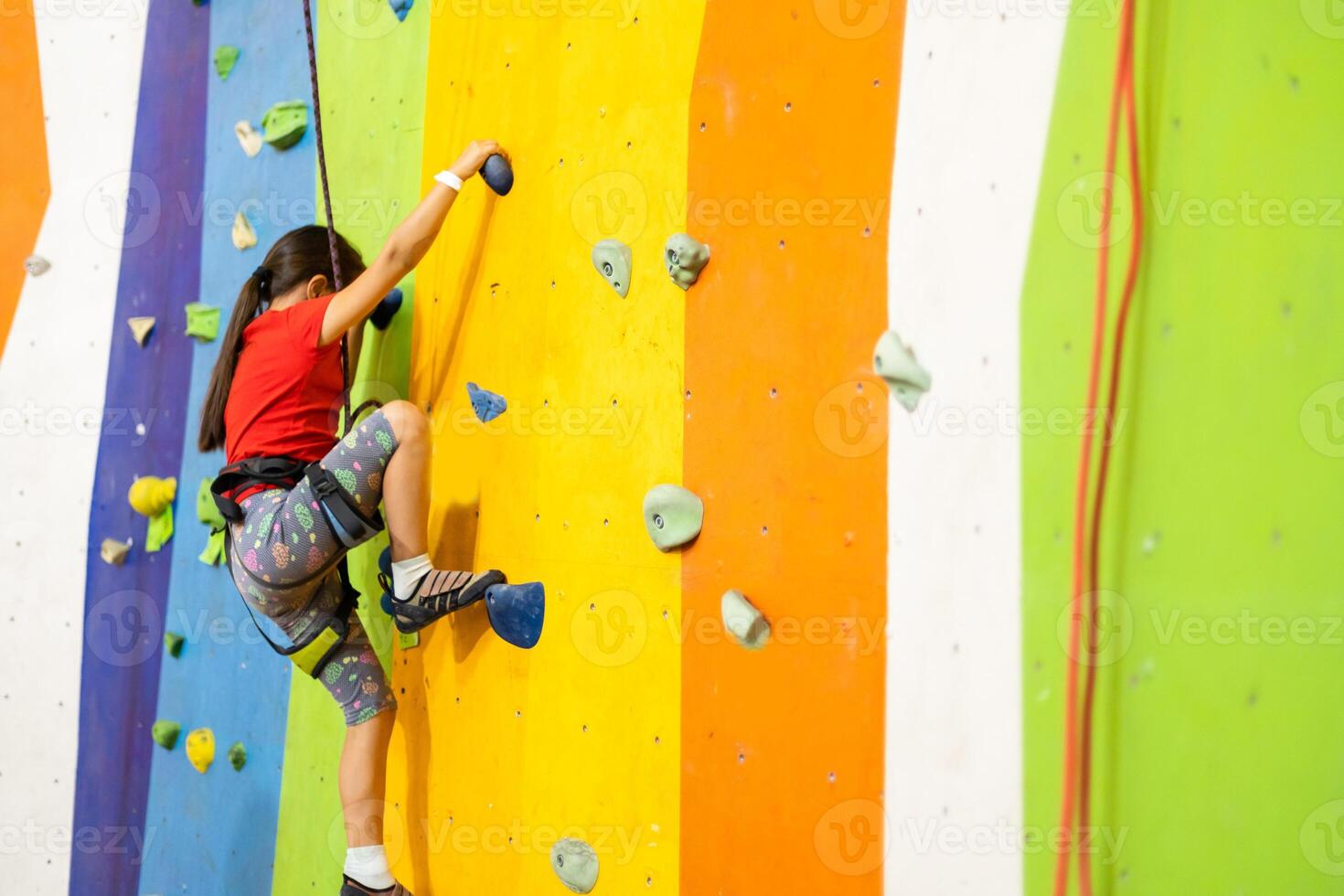 Little Girl Climbing Rock Wall photo