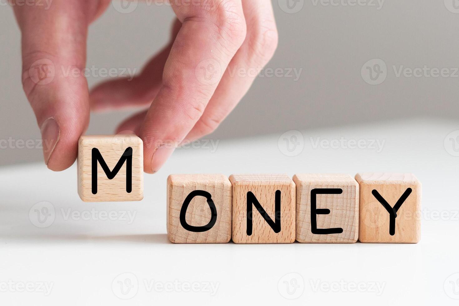 Spend or make money symbol. Businessman turns cubes and changes concept words Spend money to Make money. Beautiful white table white background. Business spend or make money concept. Copy space. photo