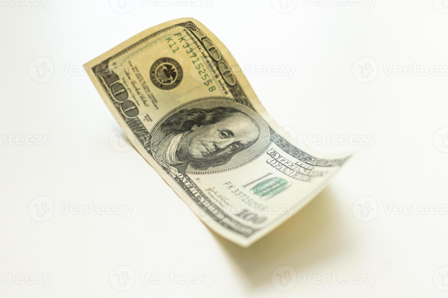 The one hundred dollars close up isolated on a white background photo